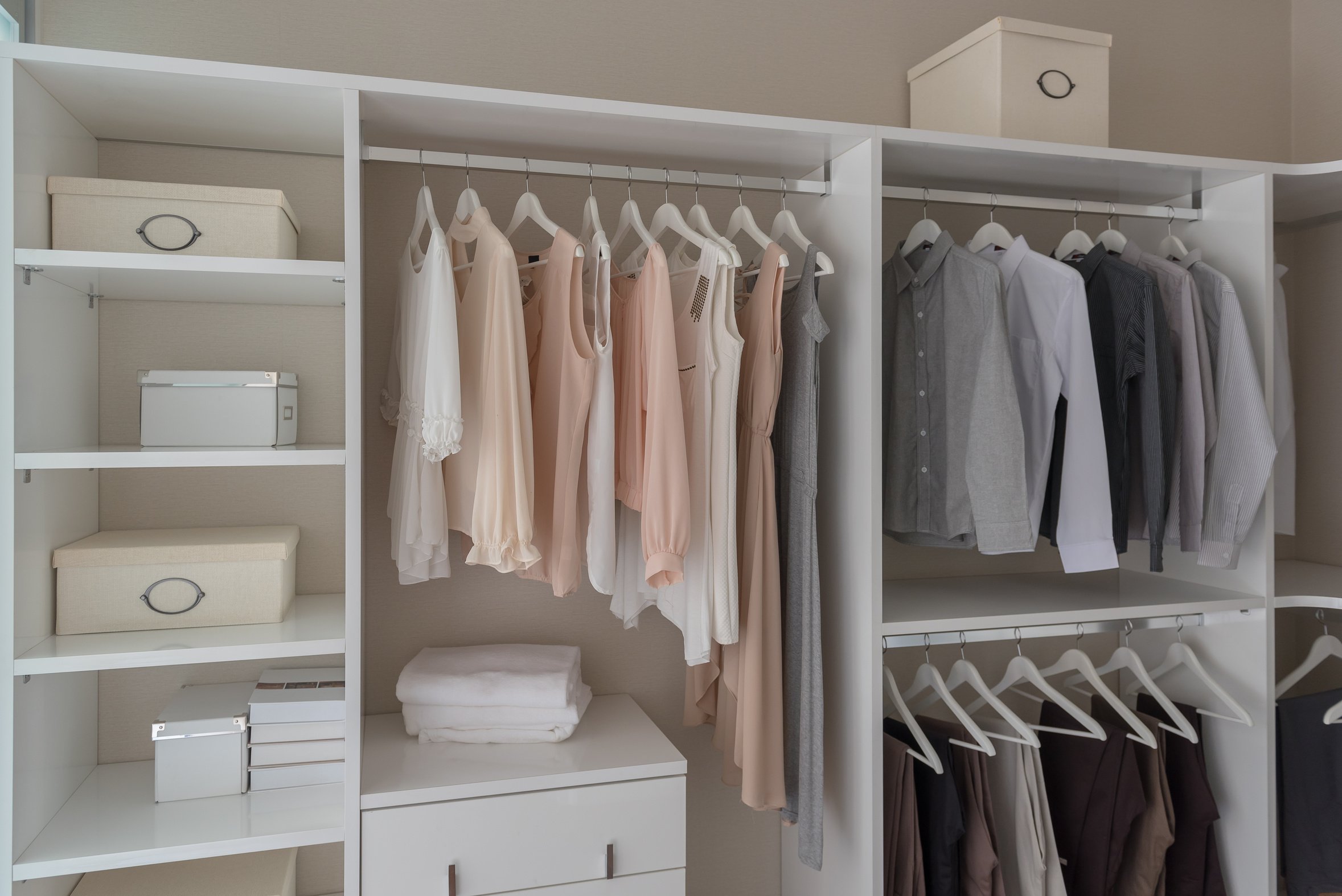 modern closet with clothes hanging